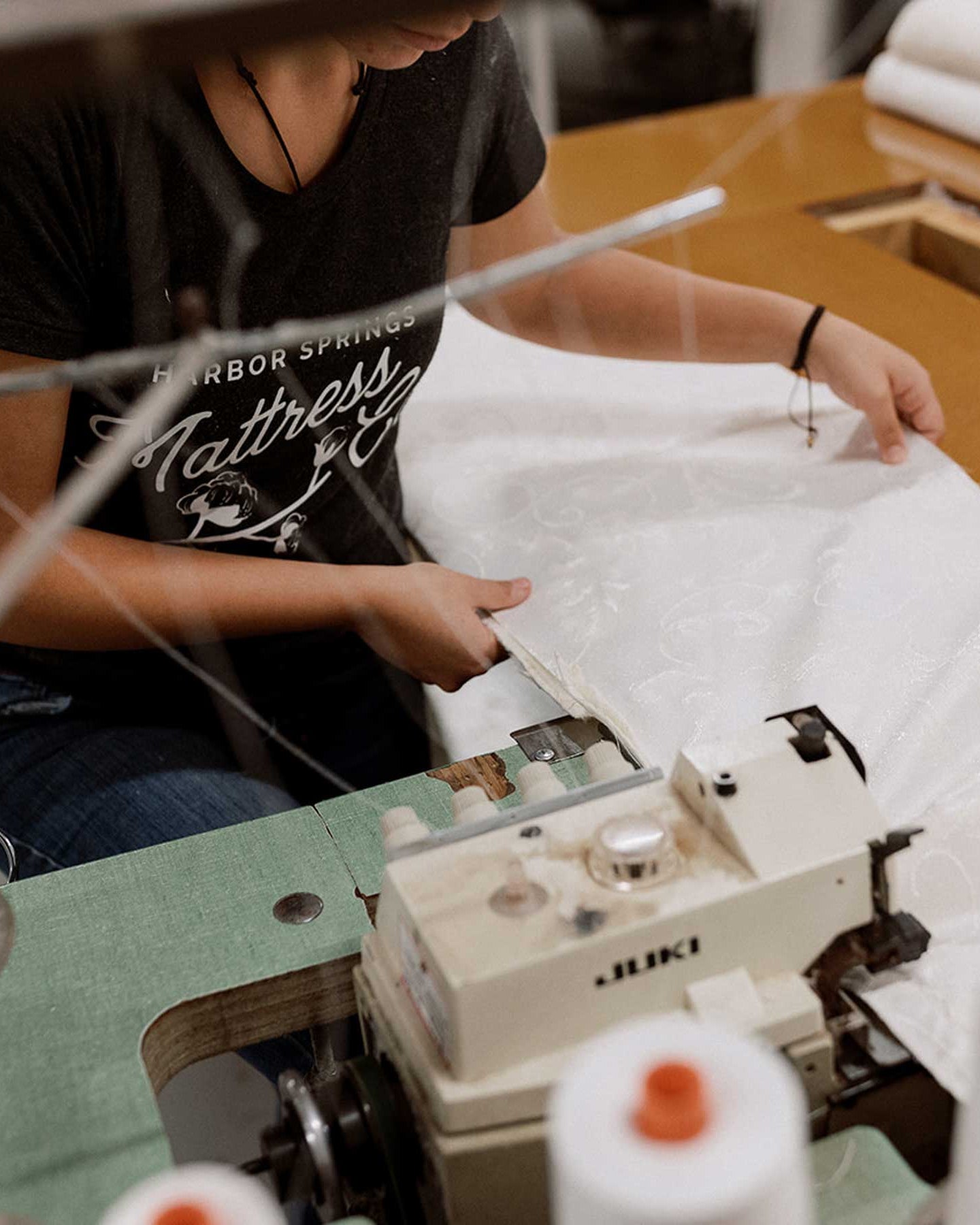 Seamstress sewing organic fabric for mattresses at Harbor Springs Mattress Co in harbor springs michigan