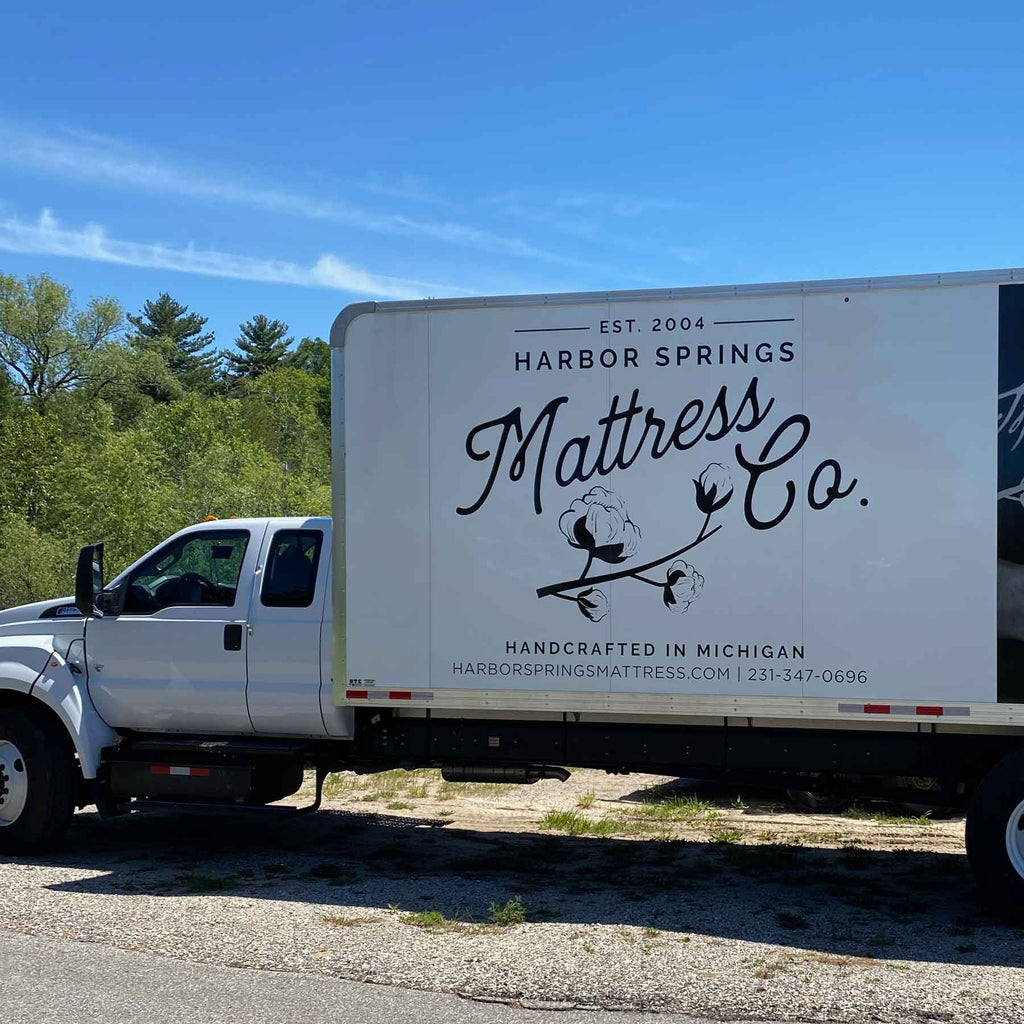 Harbor Springs Mattress Delivery Truck in a driveway ready to deliver organic mattress into a persons home.