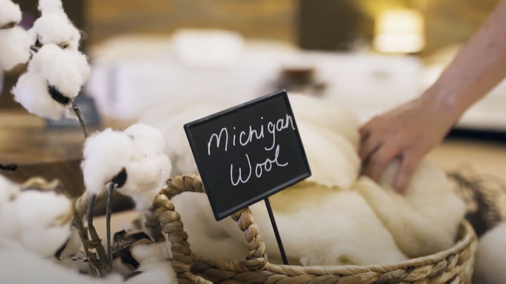 Sign saying Michigan Wool in a basket of wool used in mattress making at HSMC.