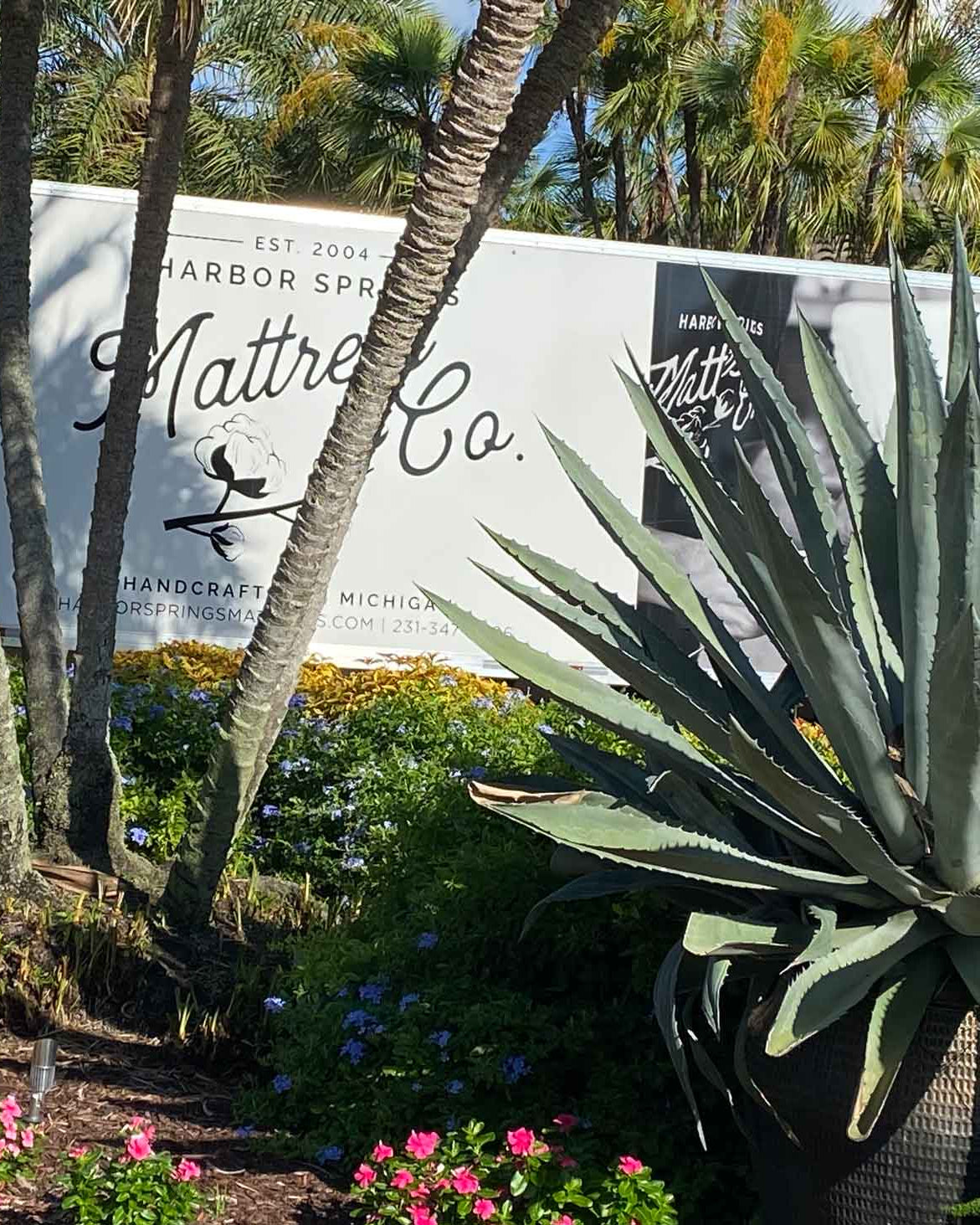 Harbor Springs Mattress Delivery Truck in a driveway with flowers in the garden in Naples, Florida