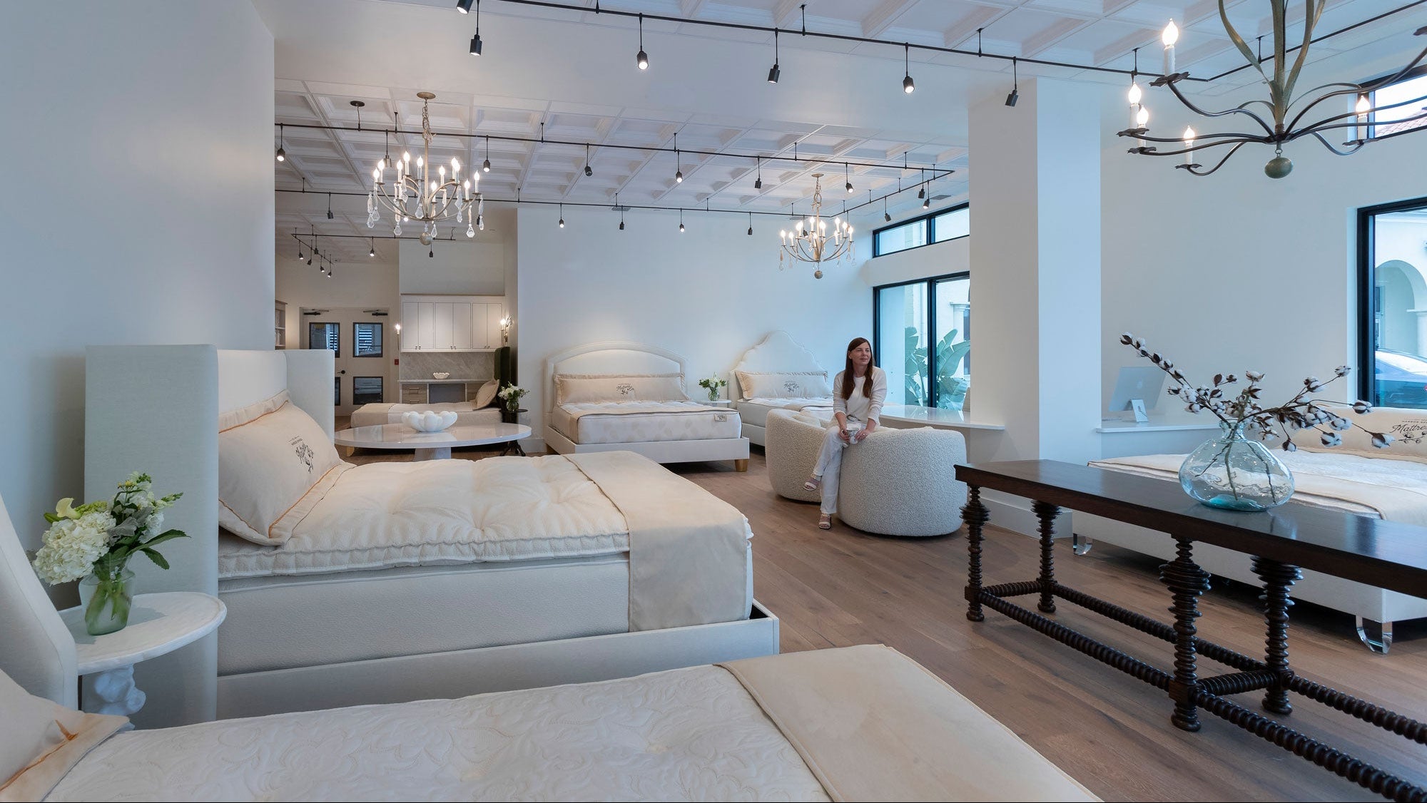 Owner relaxing in a luxury upscale mattress showroom by harbor springs mattress in naples florida