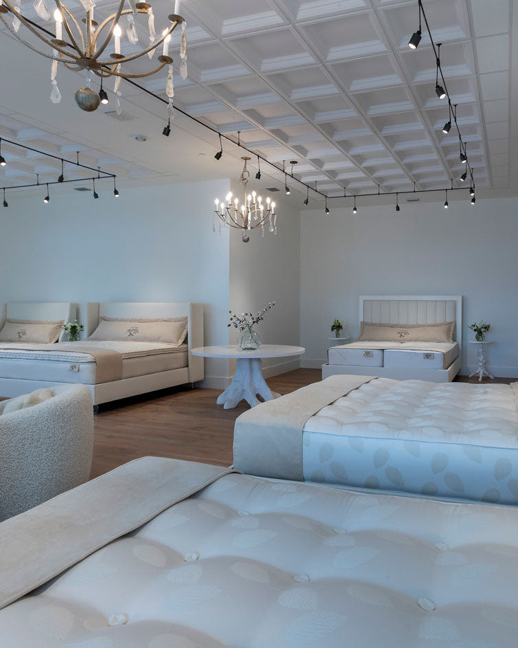 interior of luxury mattress store by harbor springs mattress co showing several hand tufted organic beds