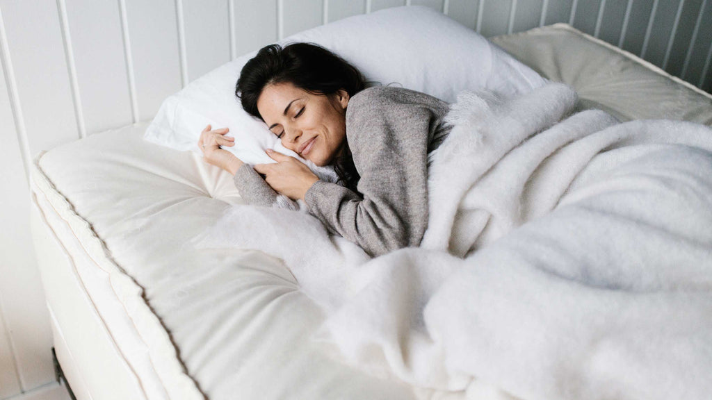 Woman sleeping comfortably on a natural and organic trillium mattress.