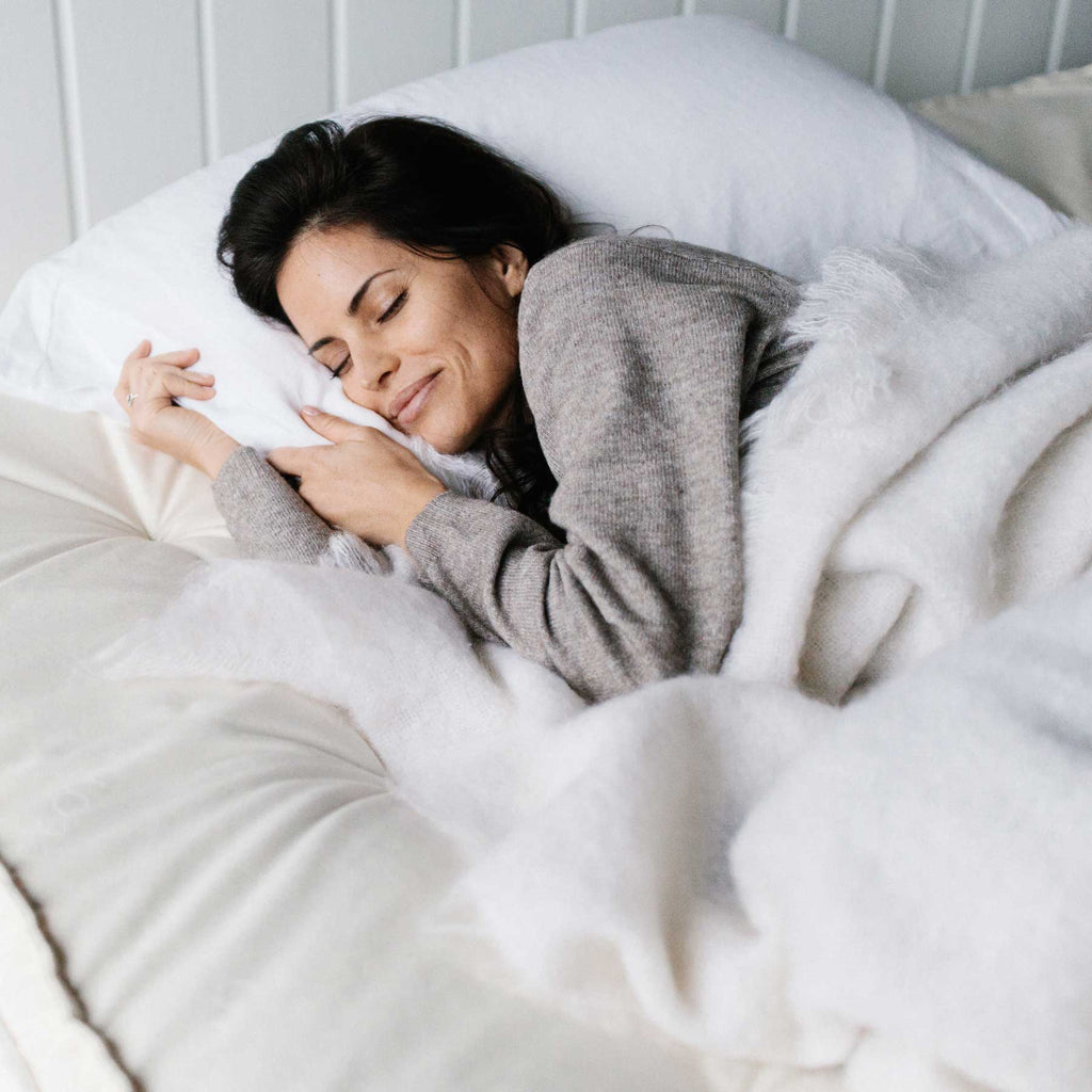 Woman sleeping comfortably on a luxury Trillium Mattress from Harbor Springs Mattress Company.